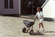man spreading grass seed